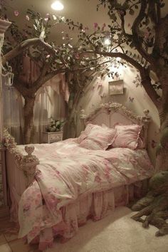 a bedroom decorated in pink and white with flowers on the bed, tree branches hanging over the headboard