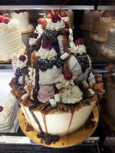 a display case filled with lots of different types of cakes and desserts on top of each other