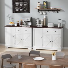 a dining room table with chairs and a chalkboard on the wall above it that says coffee