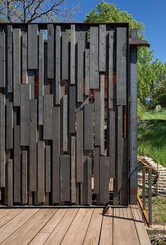 a wooden structure that is made out of wood planks and has vertical slats on the sides