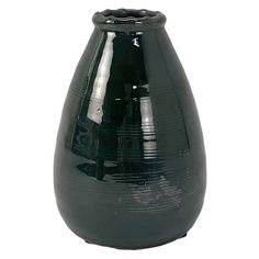 a black vase sitting on top of a white table