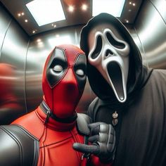 two people dressed in costumes with masks on