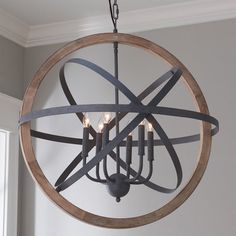 a circular chandelier with candles hanging from it