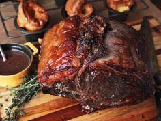 a large piece of meat sitting on top of a wooden cutting board