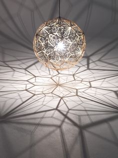 a light that is hanging from the ceiling in a room with white walls and flooring