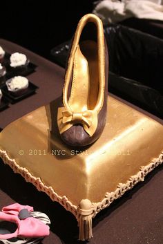 a cake that is shaped like a pair of shoes on top of a gold plate