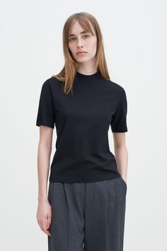 Mock Neck Tee Classic Stretch T-shirt For Workwear, Cotton T-shirt With Ribbed Collar For Work, Black High Neck Classic Top, Classic Black High Neck Top, Classic High Neck Black Top, Classic Short Sleeve T-shirt For Fall, Classic Black Funnel Neck Top, Cotton Turtleneck Tops For Everyday, Classic Black Turtleneck Top