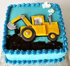 a blue and yellow cake with a tractor on it