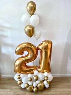 a gold and white number twenty balloon arrangement