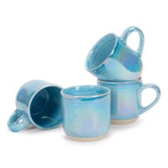 three blue mugs with lids on each one and the other two are stacked up