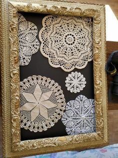 an ornate gold frame with doily cut out of it's sides and hanging on the wall