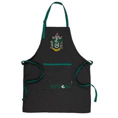 an apron with sly crest on the front and green trimmings, hanging from a hook