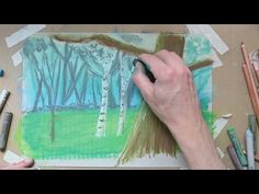 someone is drawing trees with colored pencils