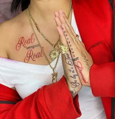 a woman with tattoos on her chest and hands folded in front of her chest, both holding their hands together