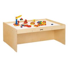 a wooden table with toy cars and trucks on it in front of a white background