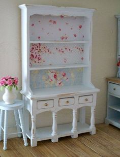 a white dollhouse desk and chair with flowers on it