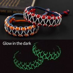 glow in the dark bracelets with braiding and beads on each side are shown next to an open book