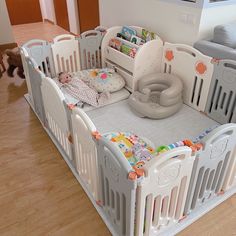 there is a baby crib in the middle of the room with toys on it