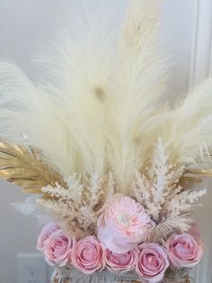 a basket with flowers and feathers in it