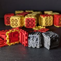 there are many small lego blocks on the table together, and one is yellow or red