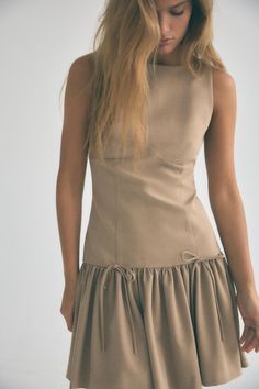 Round neck sleeveless dress. Balloon hem with front bows. Invisible back zip closure. Waistcoat Dress, Cardigan Sweater Vest, Tan Dresses, Cardigan Shirt, Cardigan Sweater Dress, Round Neck Dresses, Leather Shirt, Sleeveless Mini Dress, Dress With Bow