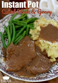 a plate with mashed potatoes, green beans and gravy on it that has the words instant pot baked steak and gravy