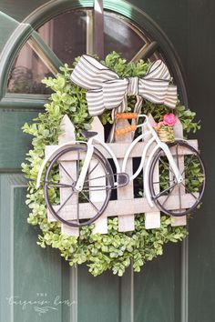 a bicycle is mounted to the front door with bow ties on it's handlebars