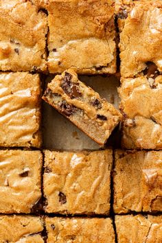 several squares of brownies with chocolate chip toppings are arranged on top of each other