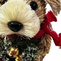 a close up of a stuffed animal with christmas decorations on it's head and nose