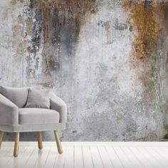 a chair sitting in front of a concrete wall with moss growing on it's sides