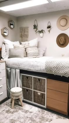 a bedroom with a bed, dressers and hats on the wall