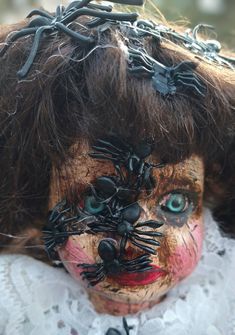 an old doll with spider webs on her head