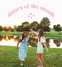 two women standing in front of a lake holding hands with the words sisters of the month above them