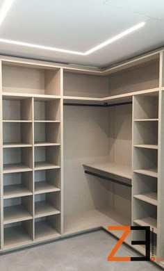 an empty walk in closet with shelves and lights