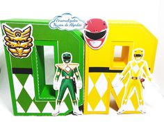 two action figures are posed next to each other in front of a green and yellow box