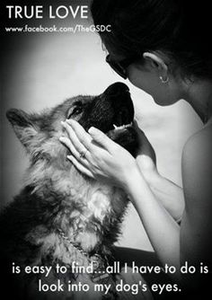 a woman is kissing her dog's face with the caption true love