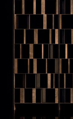 an abstract black and gold wallpaper with squares in the middle, on a dark background