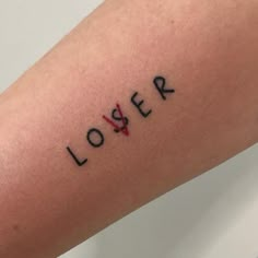 a person with a tattoo on their arm has the word lover written in red ink