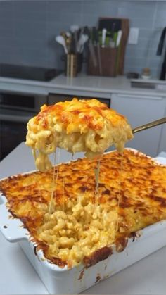 a casserole dish being lifted with a spatula