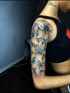 a woman with a flower tattoo on her arm