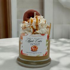 a glass jar filled with lots of food on top of a white tablecloth covered table