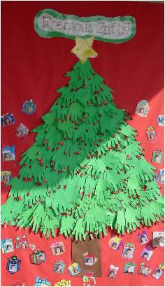 a christmas tree made out of paper on a red background with other items around it