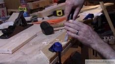 a man is working on something in his workshop with woodworking tools and pliers