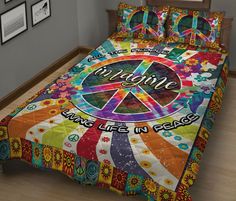 a bed with a peace sign and flowers on it