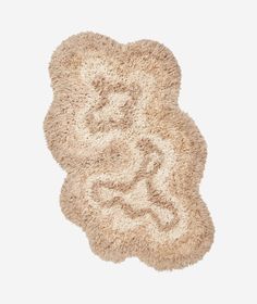 a white rug with an animal design on it's side and the floor is made out of shaggy material