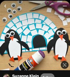 an image of penguins made out of paper and glue on a table with craft supplies