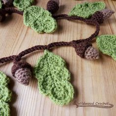 crocheted leaves and acorns on a wooden surface