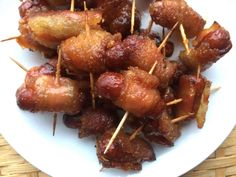 bacon wrapped in toothpicks on a white plate