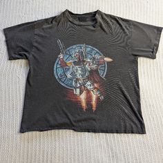 a black t - shirt with an image of a robot on it