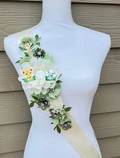 a white mannequin with flowers on it